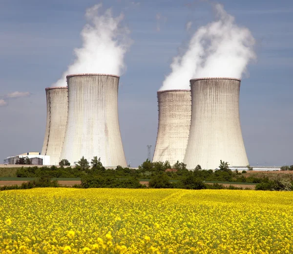 Cooling tower and rapeseed field — Stock Photo, Image