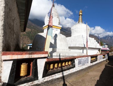 Stupa with prayer flags and wheels