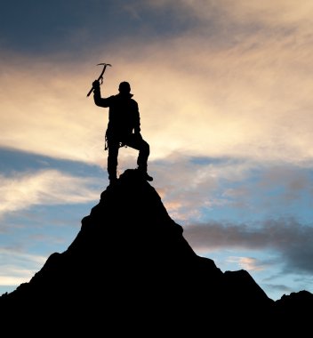 man on mountains with ice axe in hand