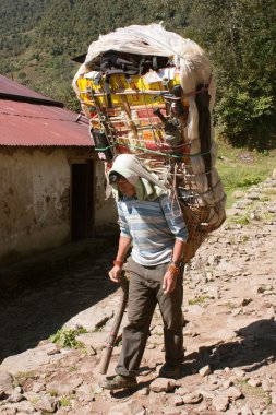  Sherpa porters with goods way to Everest base camp