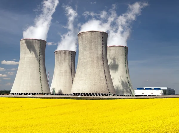 Cooling tower and rapeseed field — Stock Photo, Image