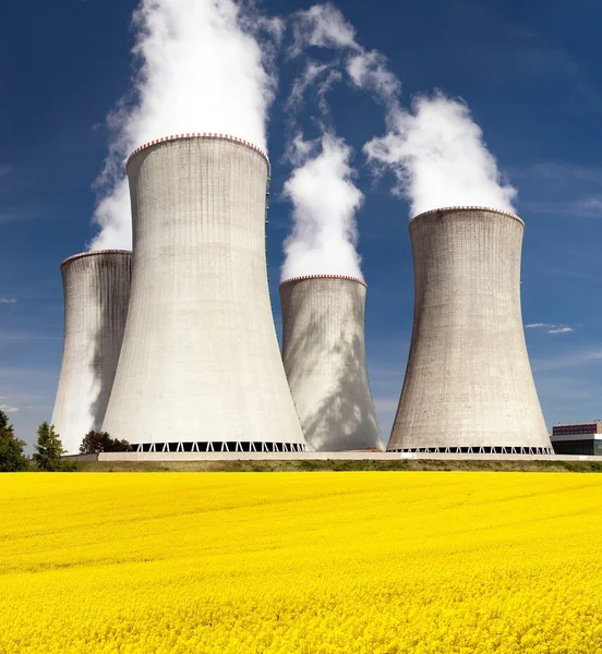 Cooling tower and rapeseed field — Stock Photo, Image