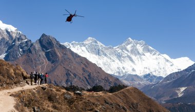 View of Everest and Lhotse with helicopter and tourists