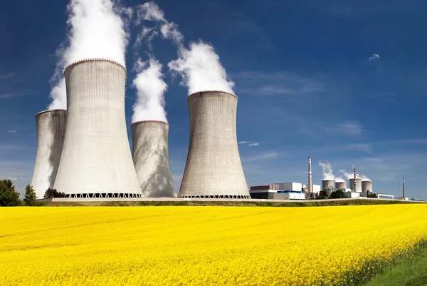 Cooling tower and rapeseed field — Stock Photo, Image