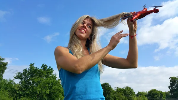 Blonde girl with drone in the hair — Stock Photo, Image