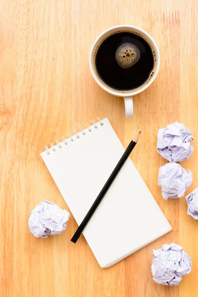 Black coffee and notepad on wooden table — Stock Photo, Image