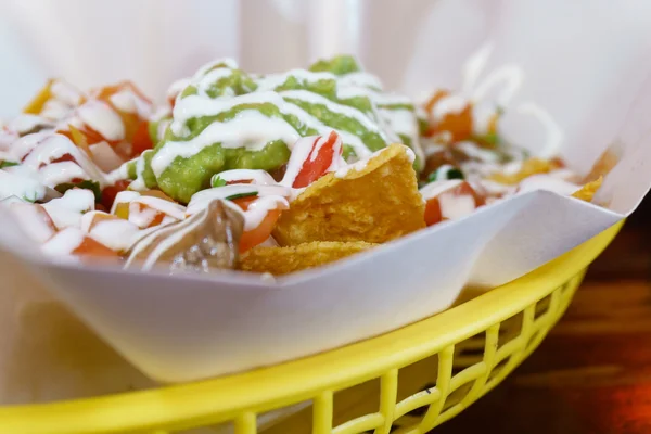 Beef Nacho with cheeses, salsa, guacamole and sour cream — Stock Photo, Image