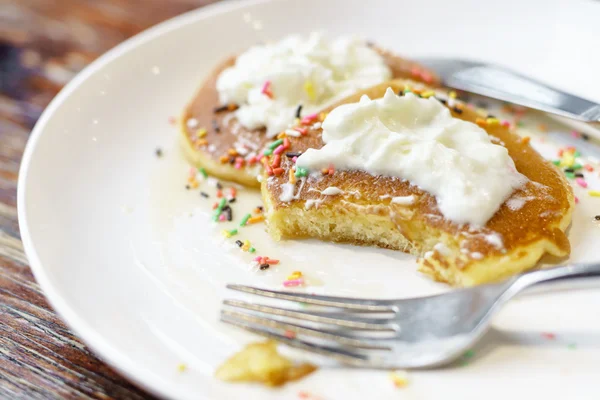 Eating whipped cream pancakes — Stock Photo, Image