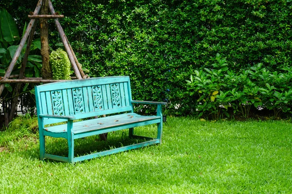 Vintage bench in grass garden — Stock Photo, Image