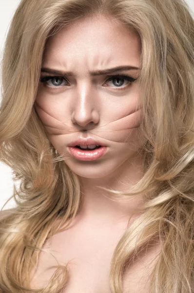 Blonde girl with threads on face — Stock Photo, Image