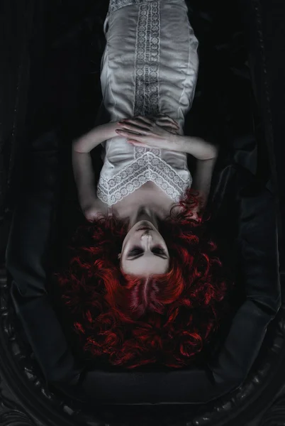 Female vampire lying in the coffin — Stock Photo, Image