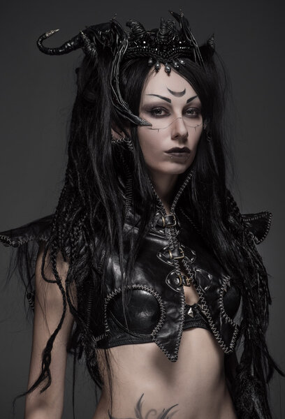 Woman dark elf warrior in black costume on gray background isolated
