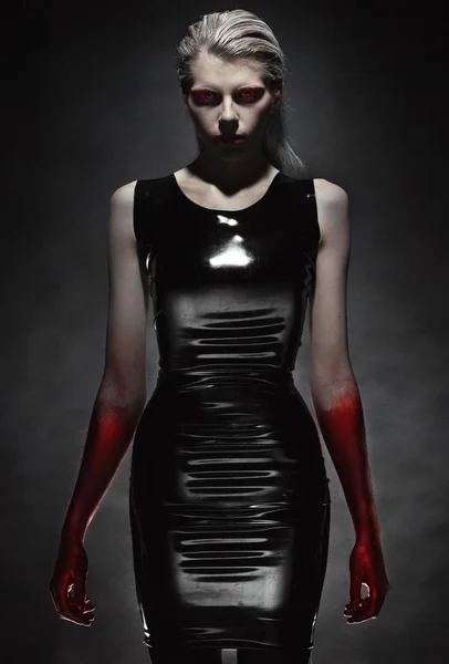 Pale woman in black latex dress Stock Image