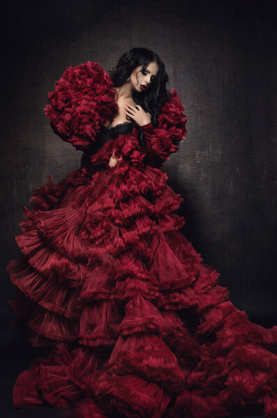 brunette  woman in  red fluffy bolero