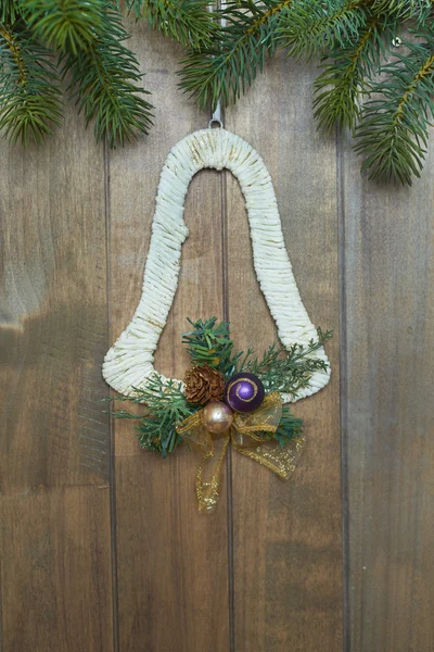 Christmas bell on wooden background — Stock Photo, Image