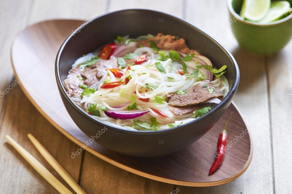 Pho bo, rice noodle soup with sliced beef — Stock Photo © MarinaN 52487279