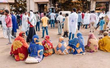 Azezo, Amhara Region, Ethiopia - April 21, 2019: Orthodox Christian people behind church waiting for mass on the street during easter holiday. Bahir Dar, Ethiopia