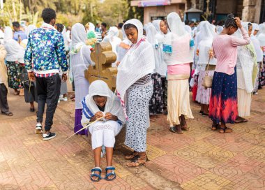 Azezo, Amhara Region, Ethiopia - April 21, 2019: Orthodox Christian people white dressed walk to mass on the street during easter holiday. Bahir Dar, Ethiopia