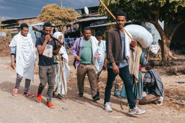 Azezo, Amhara Region, Ethiopia - April 22, 2019: Ethiopian scout in group of man on street. City Azezo, Ethiopia, Africa