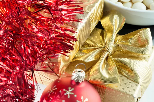 Christmas decoration and golden box with ribbon — Stock Photo, Image