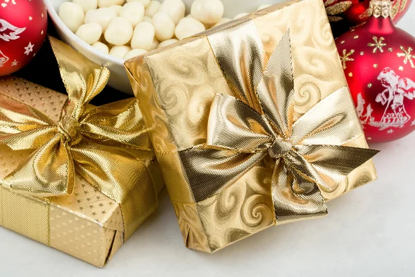 Christmas decoration and golden box with ribbon — Stock Photo, Image