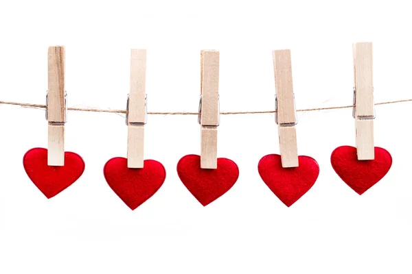 Red fabric heart hanging on the clothesline — Stock Photo, Image