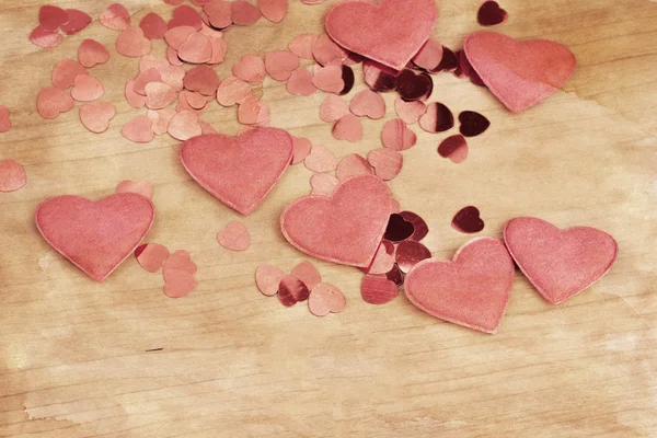 Valentine's fabric and confetti hearts on a wooden retro design background — Stock Photo, Image