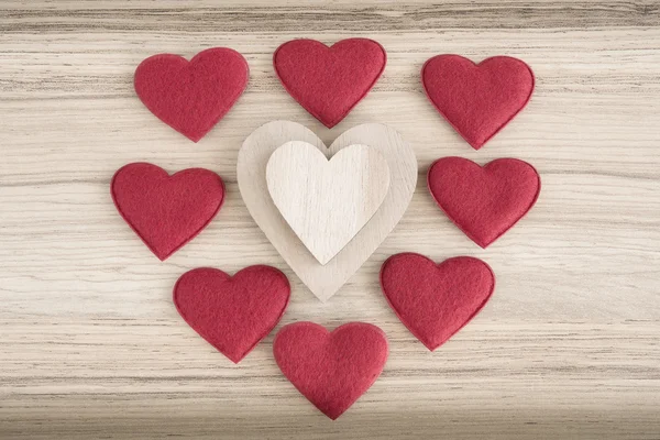 Valentine's fabric and wooden hearts on a wooden background — Stock Photo, Image