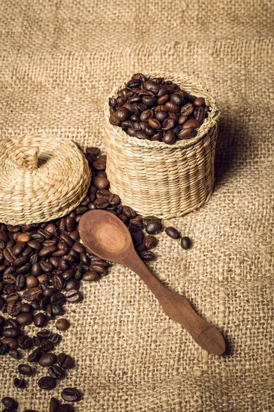 Pile of fresh and bio aromatic coffee beans and spoon and jar — Stock Photo, Image