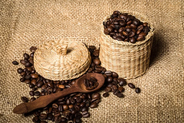 Pile of fresh and bio aromatic coffee beans and spoon and jar — Stock Photo, Image