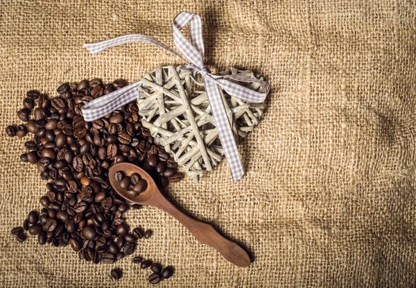 Pile of fresh coffee beans, heart and spoon — Stock Photo, Image