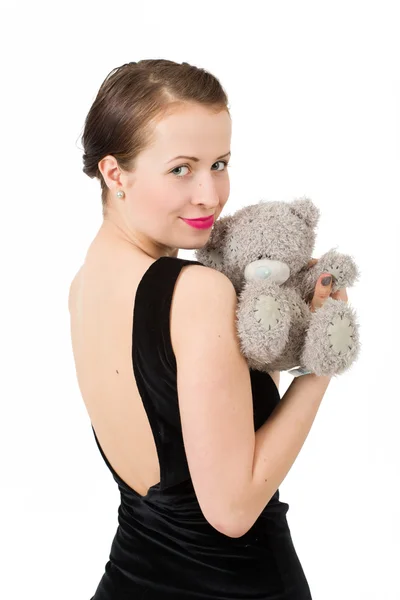 Attractive smiling brunette holding teddy bear — Stock Photo, Image