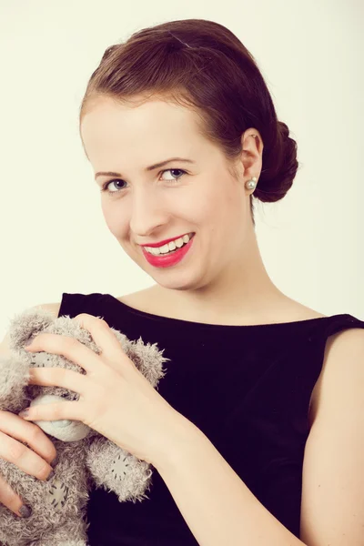 Attractive smiling brunette holding teddy bear — Stock Photo, Image