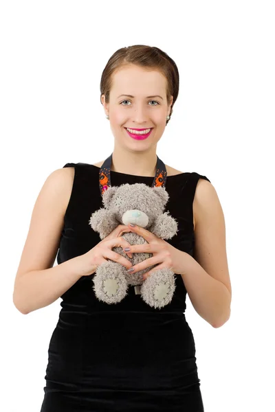 Atraktivní usměvavá brunetka drží medvídek — Stock fotografie