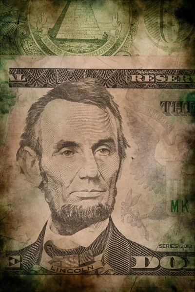Makro Abrahama Lincolna na pěti Usa dolar bankovek grunge vintage stylu — Stock fotografie