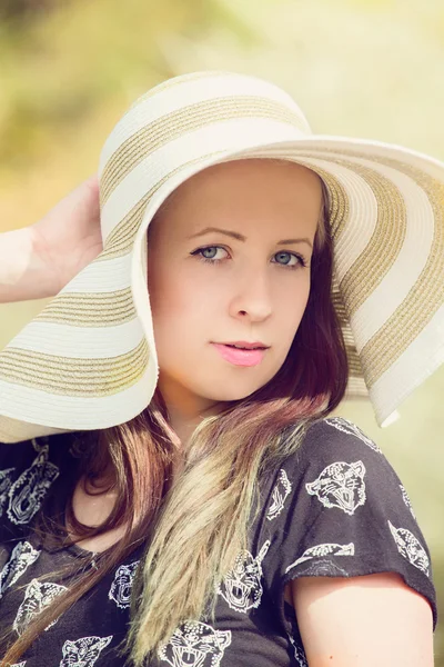 Cheerful fashionable woman in stylish hat and frock posing — Stock Photo, Image