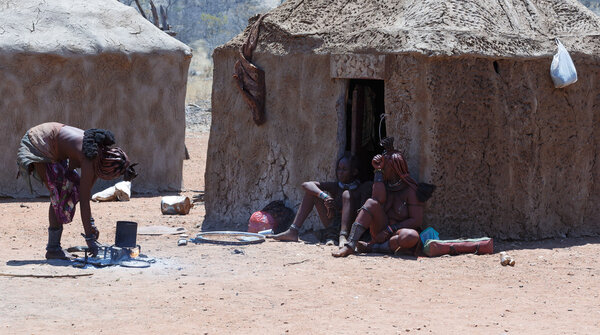 Himba woman with child in the village