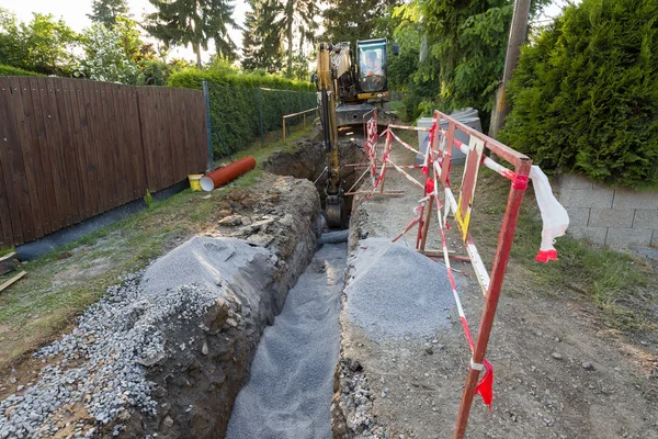 Escavatore su trincea - costruzione canalizzazione — Foto Stock