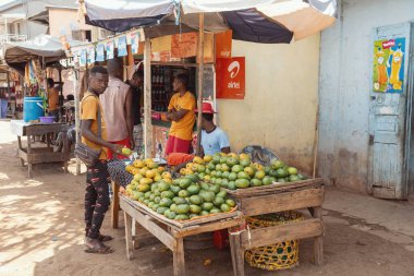 Miandrivazo, Madagascar - October 11 2025: Abundant display of green and yellow mangoes at a vendor stall in the busy market area of Miandrivazo, Menabe.