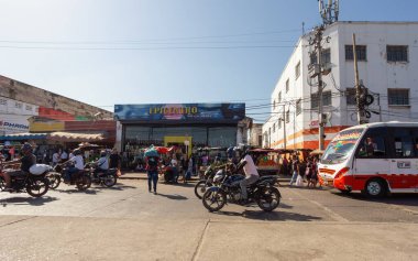 Barranquilla, Colombia - December 5 2023: Chaotic urban scene in Atlantico, showing crowded street life dominated by motorcycles and public minibuses.