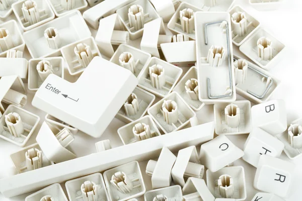 Scattered keyboard keys on white — Stock Photo, Image