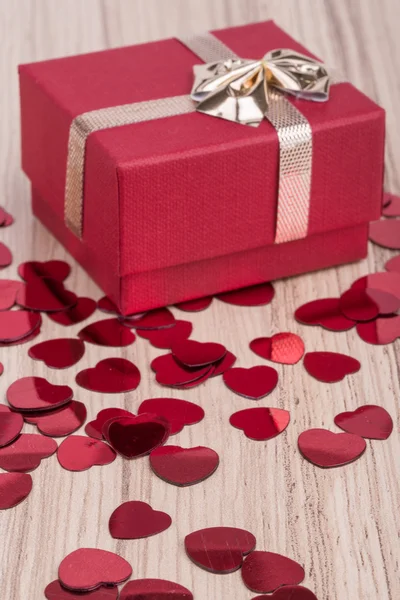Red hearts confetti on wooden background — Stock Photo, Image