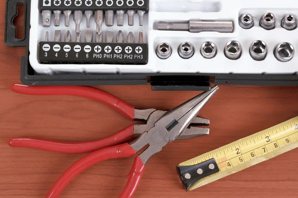 Screwdriver toolbox with set of bits, pliers and measuring tape — Stock Photo, Image