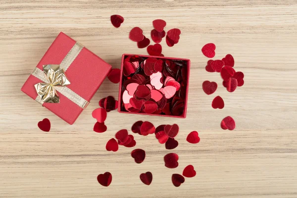 Red hearts confetti on wooden background — Stock Photo, Image