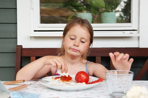 Brooding girl with her food — Stock Photo, Image