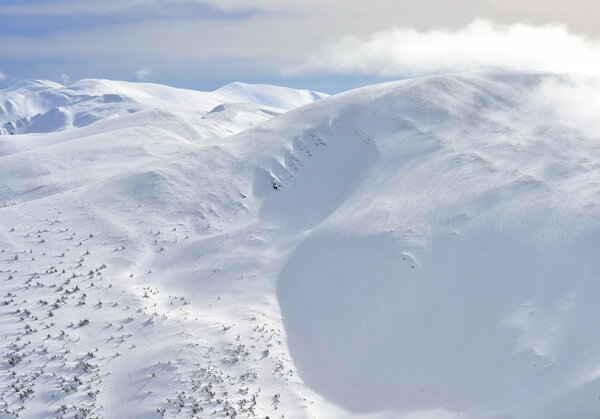 Winter on a hillside in a mountain landscape