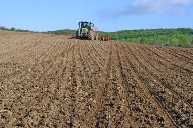 Planting corn trailed planter in the field  clipart