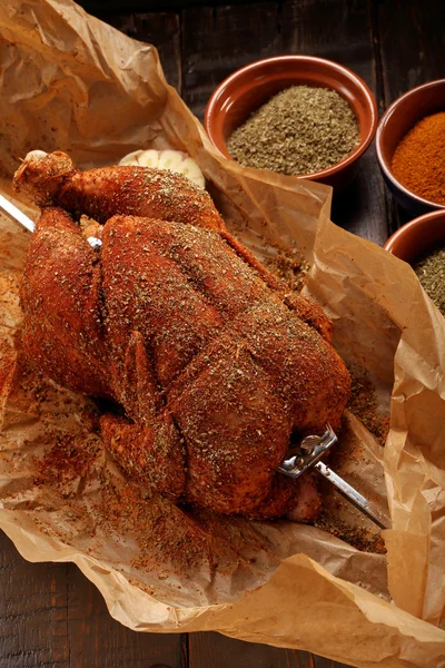 Whole raw chicken with spices ready for roasting on a spit — Stock Photo, Image