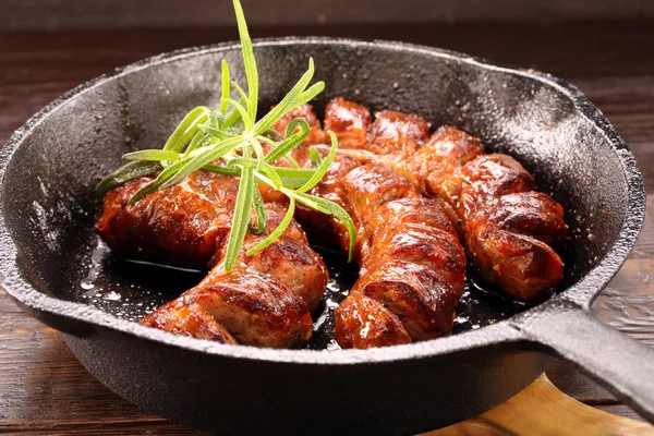 White sausage frying in a pan — Stock Photo, Image