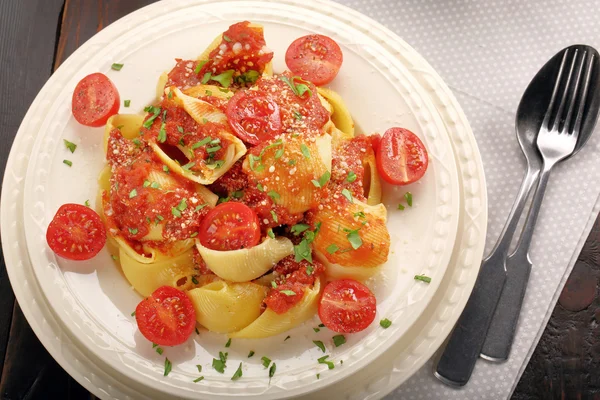 Lumaconi pasta with tomato sauce, bruschetta and salad — Stock Photo, Image